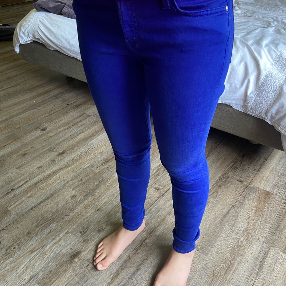 Skinny jeans in bold blue color. Gently worn with no tears or stains.